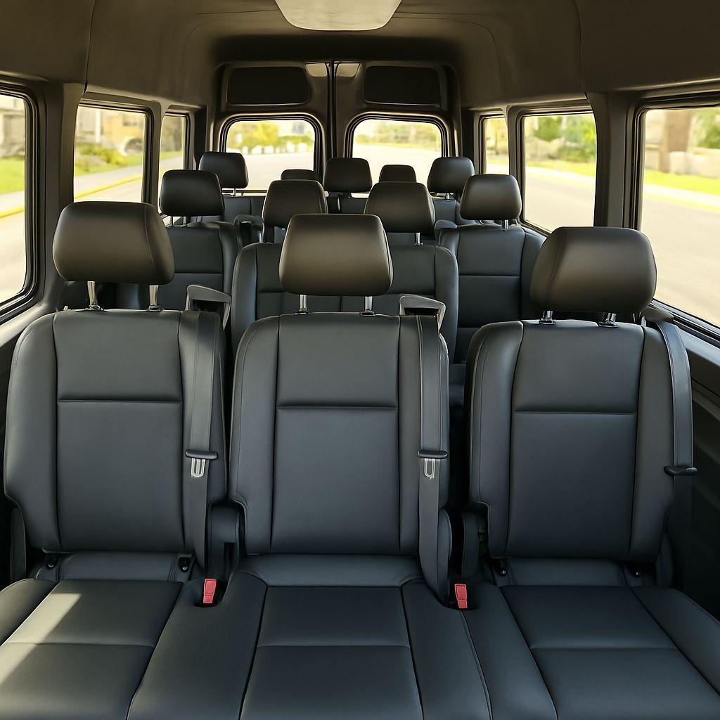 Spacious interior of a luxury sprinter van featuring premium black leather seating for group car hire services.