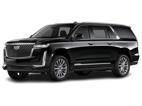 A luxury full-size black SUV with deep tinted windows waiting at a private airport terminal.