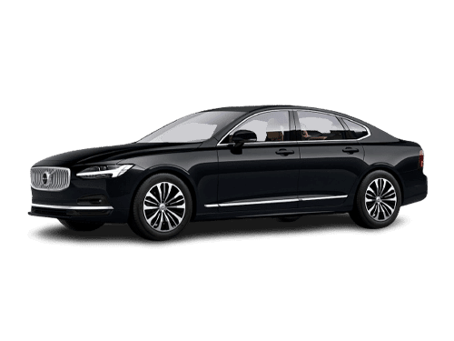 A pristine black luxury chauffeured sedan parked outside a modern corporate office building.